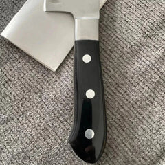 Black-handled axe on a textured surface