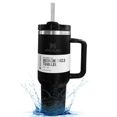 Black Stanley tumbler with handle and straw on a white background