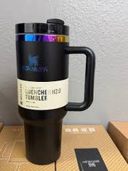 Black tumbler with colorful accents on a wooden surface