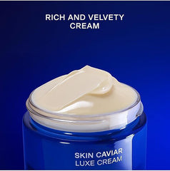 Blue jar of Skin Caviar Luxe Cream with cream oozing out on a blue background