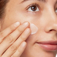 Close-up of a person applying cream to their face