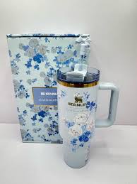 Floral-patterned mug with a matching box on a white background