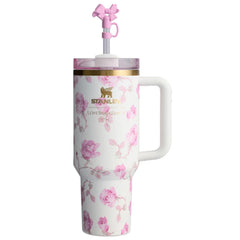 Floral-patterned tumbler with a handle and pink straw on a white background
