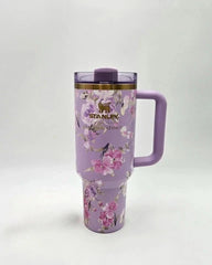 Floral-patterned tumbler with a handle on a white background