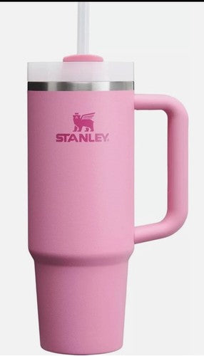 Pink Stanley mug with handle and straw on a white background