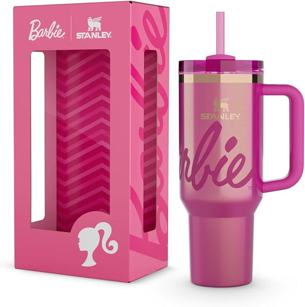Pink Stanley tumbler with handle and straw lid next to its packaging