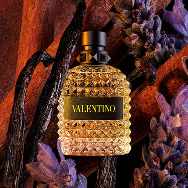 Valentino perfume bottle with decorative elements on a dark background