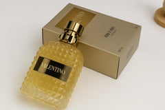 Valentino perfume bottle with diamond pattern and matching box on a white background