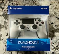 White PlayStation DualShock 4 controller in packaging on a marble surface