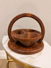 Wooden basket with handle on a marble surface against a beige wall