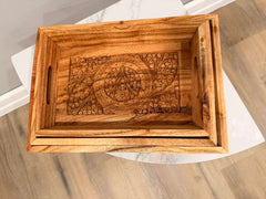 Wooden tray with intricate carvings on a wooden surface